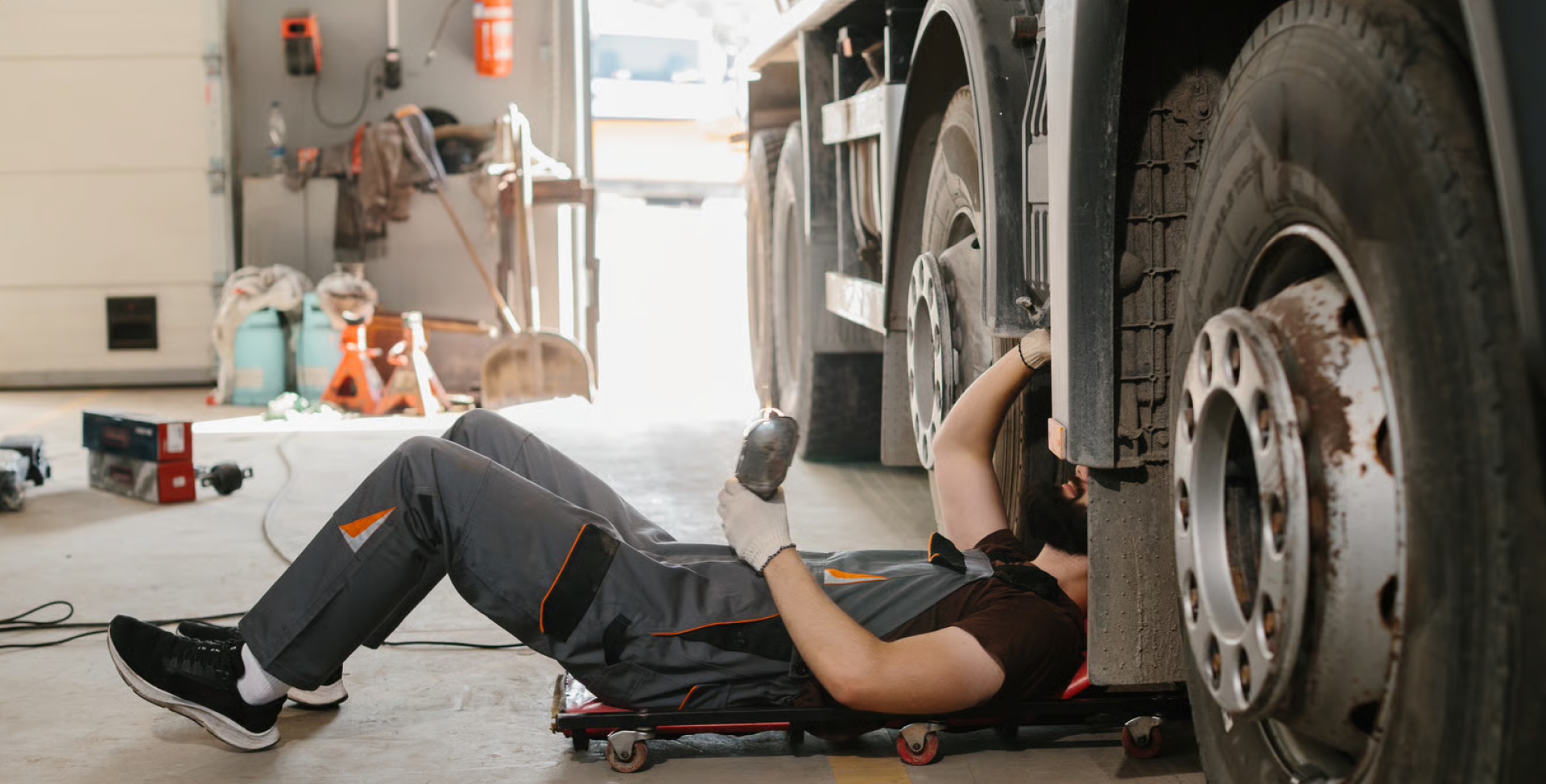 Mechanic inspecting a heavy vehicle wheel